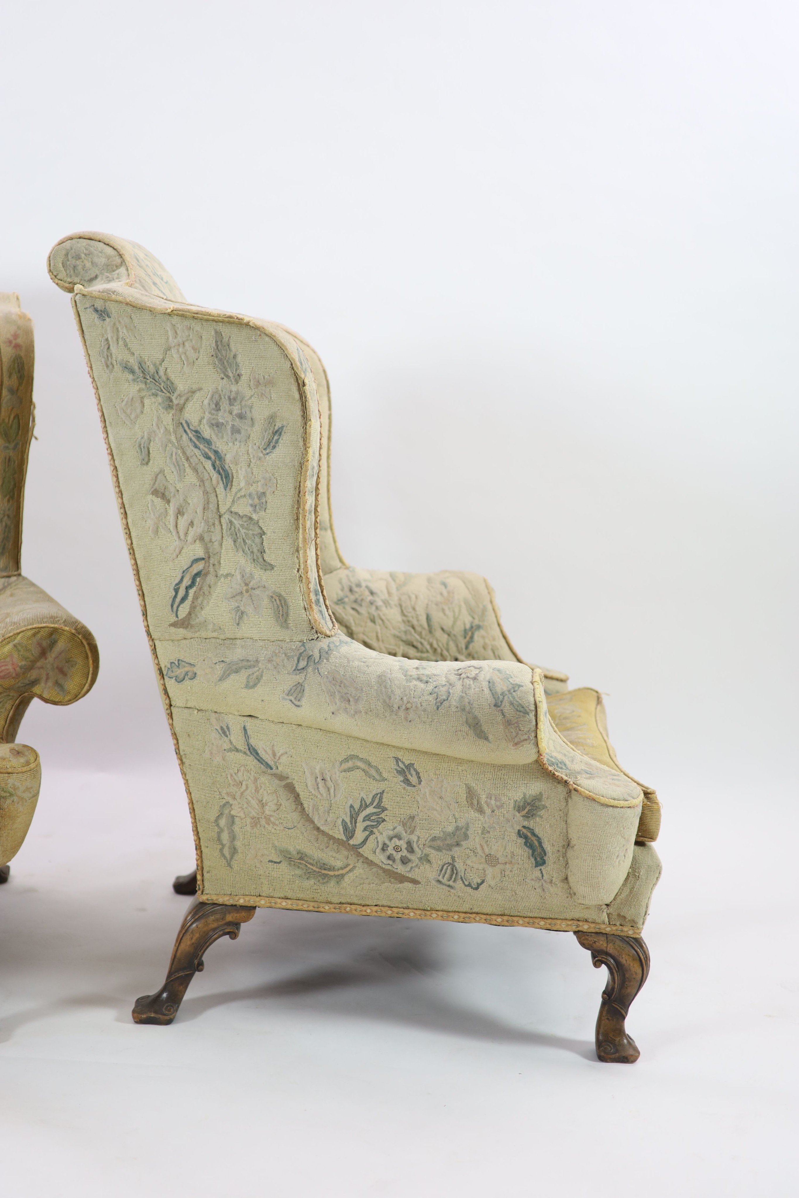 A pair of Georgian style mahogany wing armchairs W.104cm D.96cm H.120cm